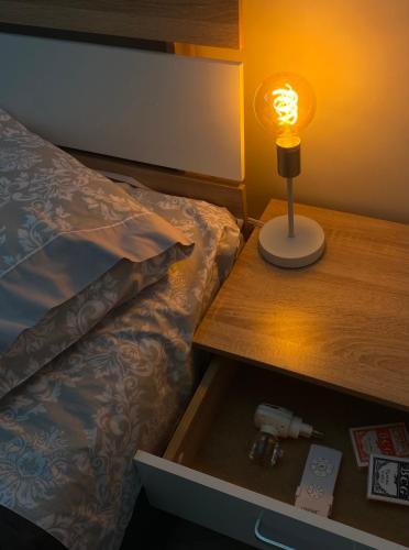 a bedroom with a bed with a lamp on a table at DiaMar in Kallithea Halkidikis