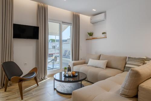 a living room with a couch and a table at Central Sunny Loft with Plunge Pool in Athens