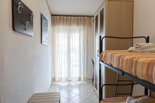 a bedroom with a bed and a window at Hotel Atlantic in Gatteo a Mare