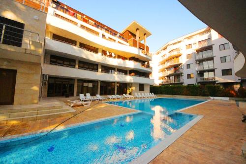 a large swimming pool in front of a building at Eden - Menada Apartments in Sunny Beach