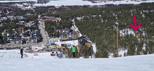 a person standing at the top of a snow covered mountain at LEVI Tunturinlaita A4, Ski-in Ski-out 3xBedroom in Levi