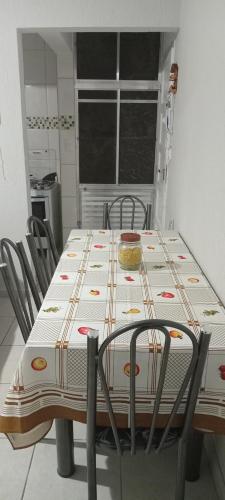 a table with chairs and a table cloth on it at Edifício Cannes AP 16A in Praia Grande