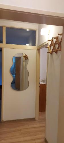 a room with a mirror on the wall and a door at Apartman Orljava in Požega
