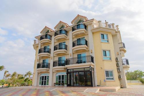 a large yellow building with balconies on it at Island on the Sea in Kenting