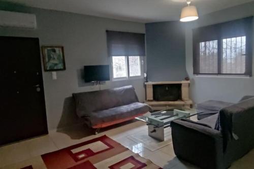 a living room with a couch and a table at Patras Ressort in Patra