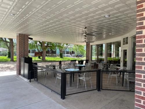a patio with tables and chairs and a fence at Western 1924 Luxury Lofts in Martindale