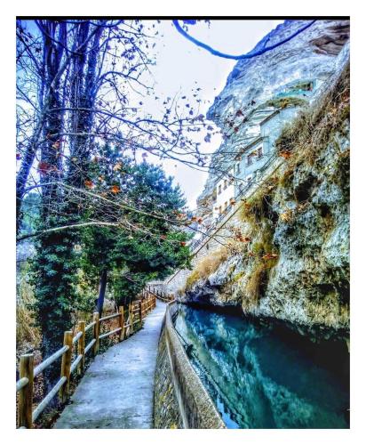 a painting of a path next to a river at Casa Rural El Abejorro in Alcalá del Júcar