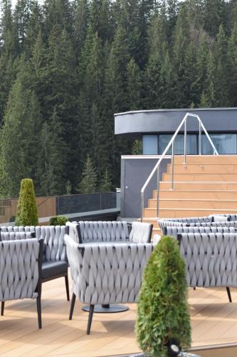 a row of chairs sitting on a patio with stairs at WOL 07 by Ribas in Bukovel