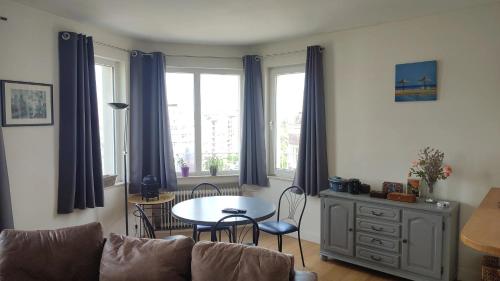 a living room with a couch and a table at One bedroom apartement with balcony and wifi at Etterbeek in Brussels