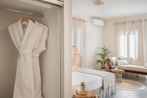 a white bedroom with a bed and a mirror at Marissa's Elegant retreats in Argostoli