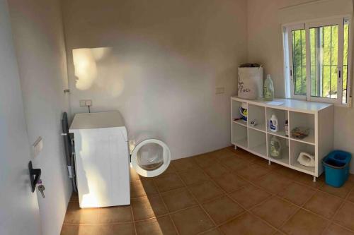 a bathroom with a white toilet in a room at Casita Abanilla in Murcia