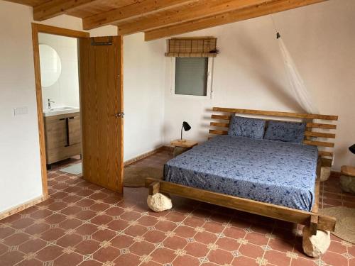 a bedroom with a bed in a room with a bathroom at Casita Abanilla in Murcia