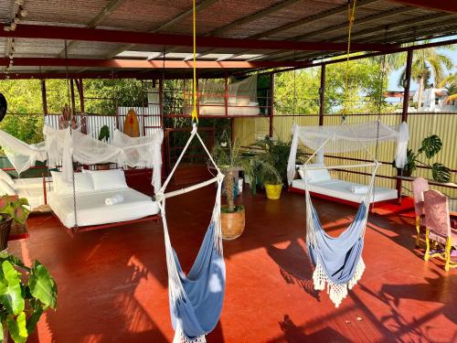 a porch with two hammocks in a room at Villas Jacquelina in Quepos