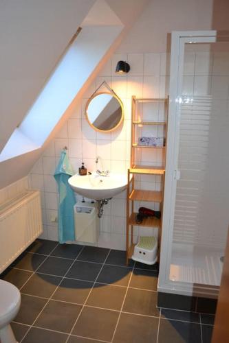 a bathroom with a sink and a toilet and a staircase at Alte Schule in Neu Wendischthun