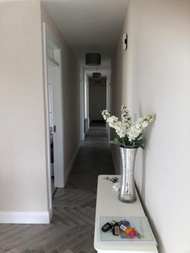 a vase of flowers on a table in a hallway at Bungalow in the countryside in Roscommon