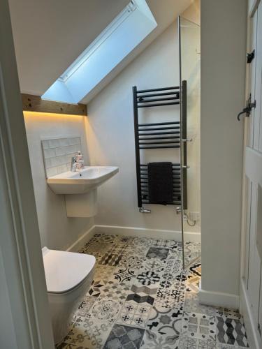 a bathroom with a sink and a toilet and a shower at Bank Top Barn Double Bedroom Self-catering 2 guests in Pickering