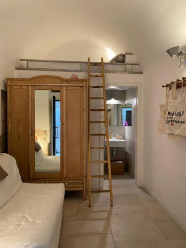 a bedroom with a bunk bed with a ladder at Old Town Moschetti 20 in Corato