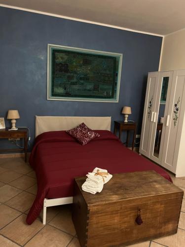 a bedroom with a bed and a table with towels at B&B Marilù in Mercato San Severino