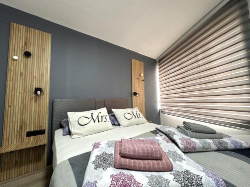 a bedroom with a bed with two pillows on it at Villa For You in Mostar
