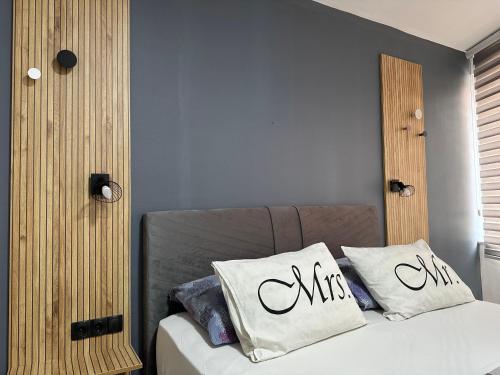 a bedroom with a bed with two pillows on it at Villa For You in Mostar