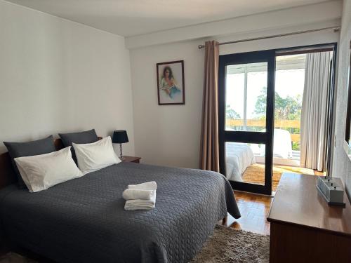 a bedroom with a bed and a sliding glass door at Discovery Apartment with patio Discovery 2 in Machico