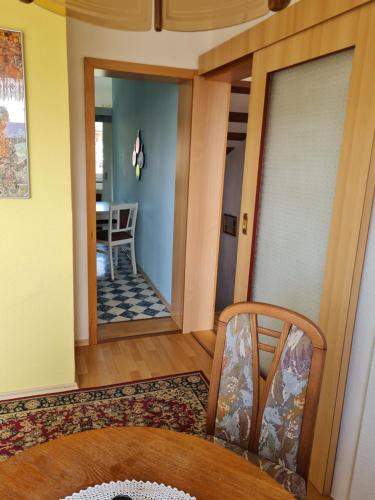 a living room with a table and a chair at Ferienwohnung Erzgebirgsblick in Bernsbach