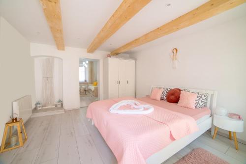 a bedroom with a pink bed with a pink blanket at Lovely Stiavnica in Banská Štiavnica