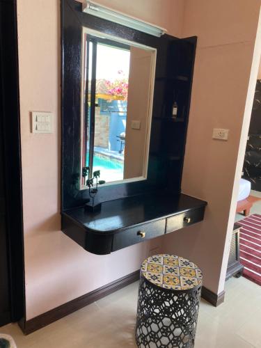 a bathroom with a black sink and a mirror at Lris villas in Phuket Town