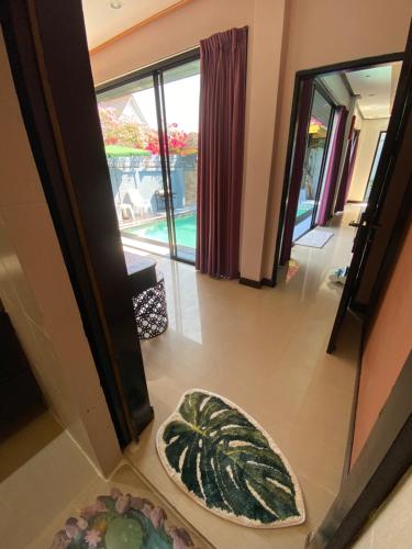 a hallway with two rugs on the floor next to a door at Lris villas in Phuket Town