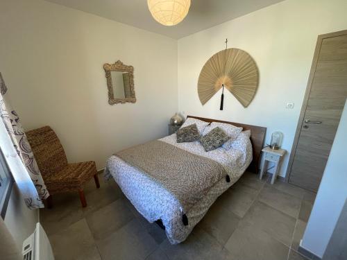 a bedroom with a bed and a chair and a mirror at Villa en Provence in Saint-Saturnin-lès-Apt