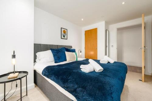 1 dormitorio con 1 cama grande con sábanas azules en In the heart of Cardiff City Centre, en Cardiff