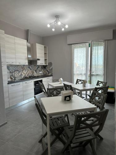 a dining room with tables and chairs in a kitchen at Bcube - santa Bona Bed & Breakfast in Pisa
