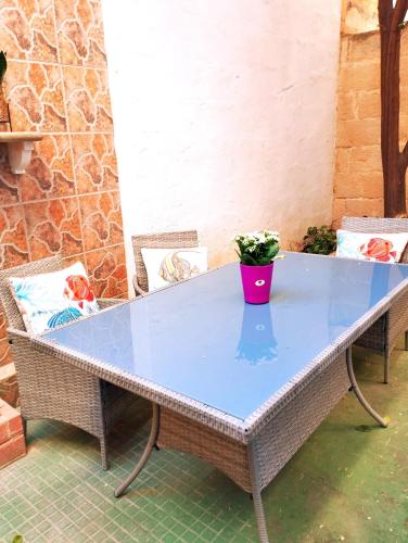 a table with a potted plant sitting on top of it at "Spirit of Malta" Historic Maltese Townhouse by the sea in Sliema