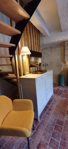 a living room with two chairs and a table at Logis La Vachère in Avallon