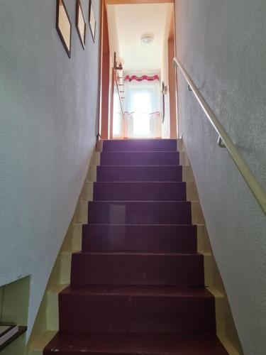 a staircase leading up to a door in a building at Ferienwohnung Erzgebirgsblick in Bernsbach