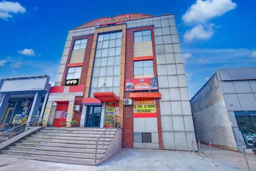 a building with stairs in front of it at Super OYO Hotel NR Residency in Banūr