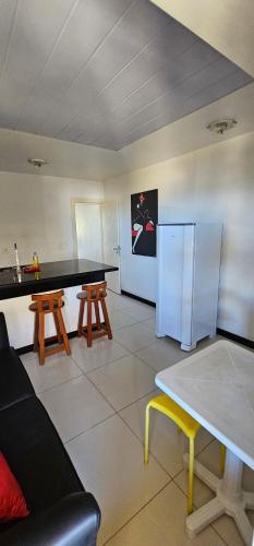 a kitchen with a refrigerator and a table and chairs at FRENTE MAR - Cumbuco - Eco Paradise in Cumbuco