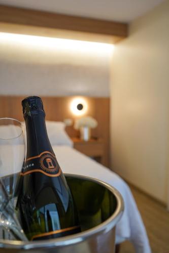 a bottle of wine in a bucket on a table at Grand Hotel Santa Ana in Cuenca