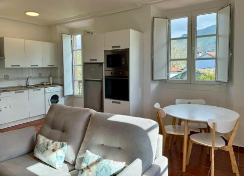 a living room with a couch and a table at Apartamentos Santa Marina in Llanes
