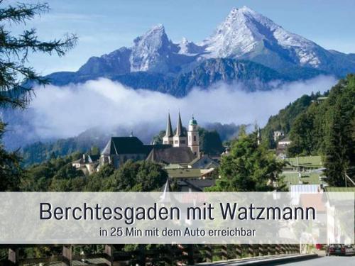a town in the mountains with a snow covered mountain at Ferienhaus Bauer in Piding in Piding