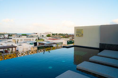 a swimming pool on the roof of a building at IT Boutique Hotel & Restaurant in Playa del Carmen