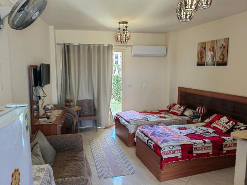 ein Schlafzimmer mit 2 Betten und ein Wohnzimmer in der Unterkunft Lasirena mini egypt in Ain Suchna