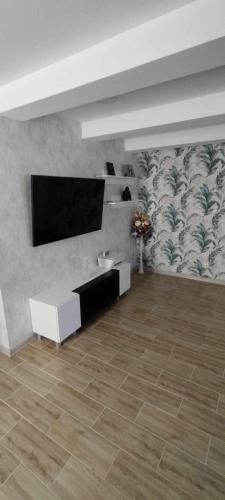 a living room with a flat screen tv on a wall at Butas Siluteje in Šilutė