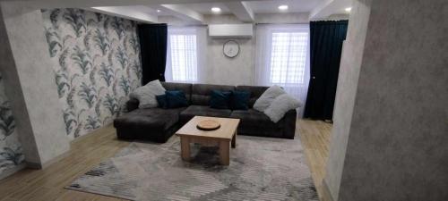 a living room with a couch and a coffee table at Butas Siluteje in Šilutė