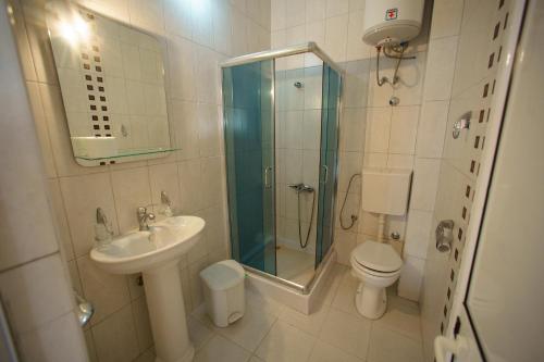 a bathroom with a shower and a sink and a toilet at Blue Sea in Bar