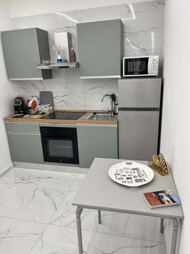 a small kitchen with a table with a plate on it at Luxury Beach House in Bari