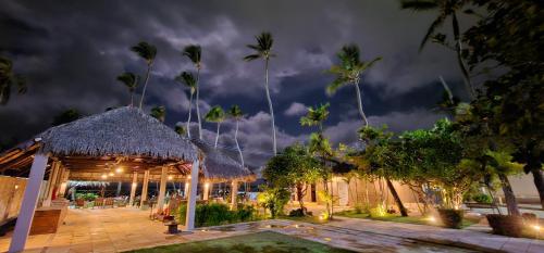 a night view of a resort with a thatch roof at FRENTE MAR - Cumbuco - Eco Paradise in Cumbuco
