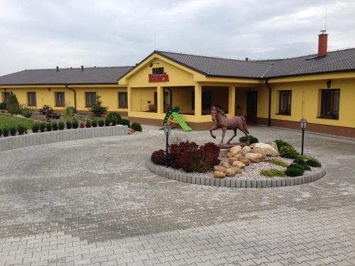 a statue of a horse in front of a building at Penzion Ranch in Hořovice