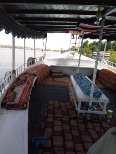 a boat with two beds on the side of it at أسوان in Aswan