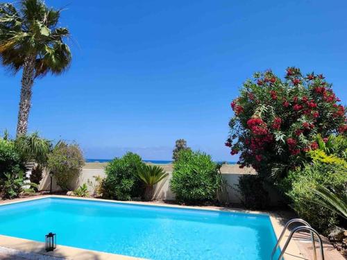 a swimming pool with a view of the ocean at Budget Escape to the seaside in Larnaca